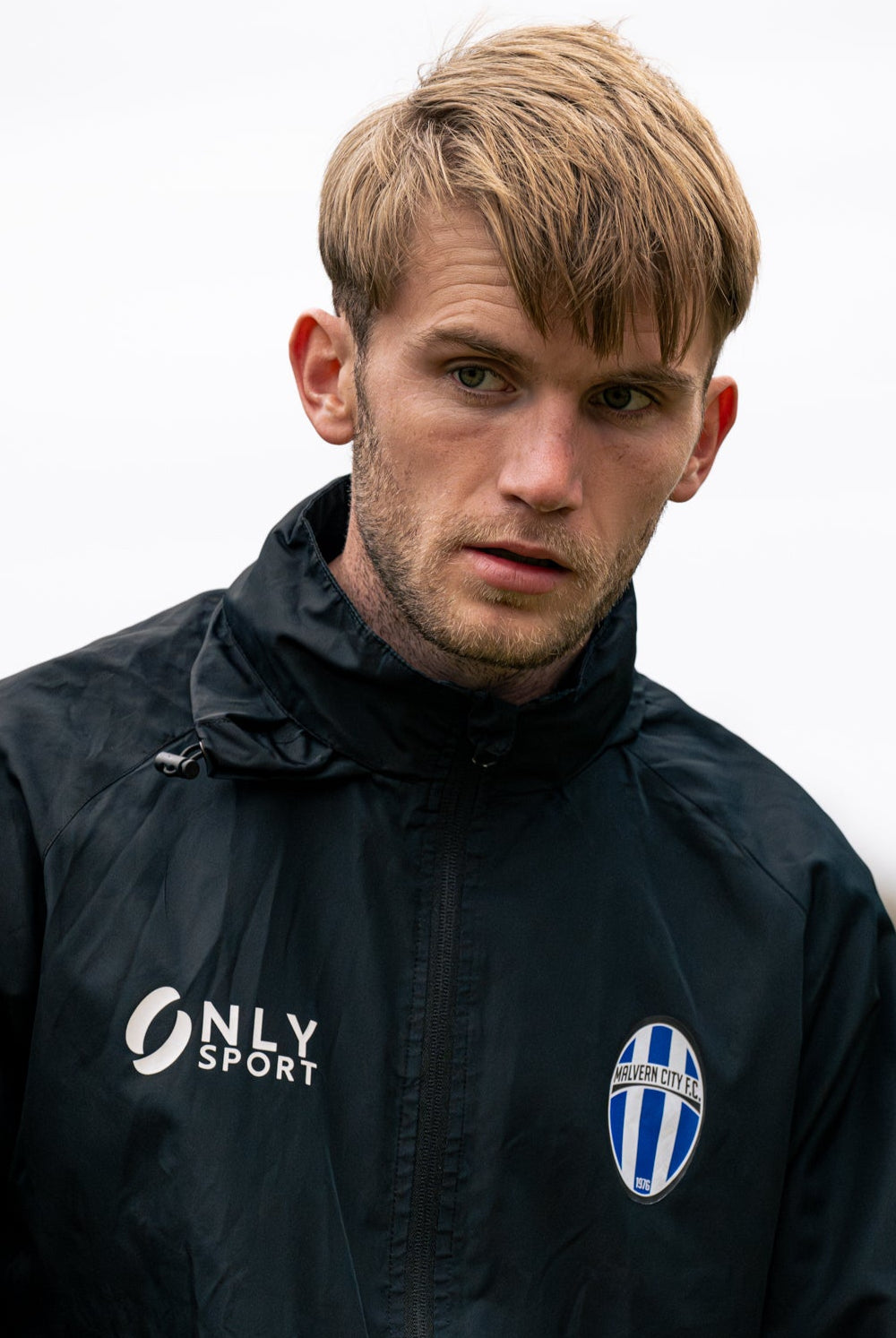Man wearing a black spray jacket with 'Only Sport' logo