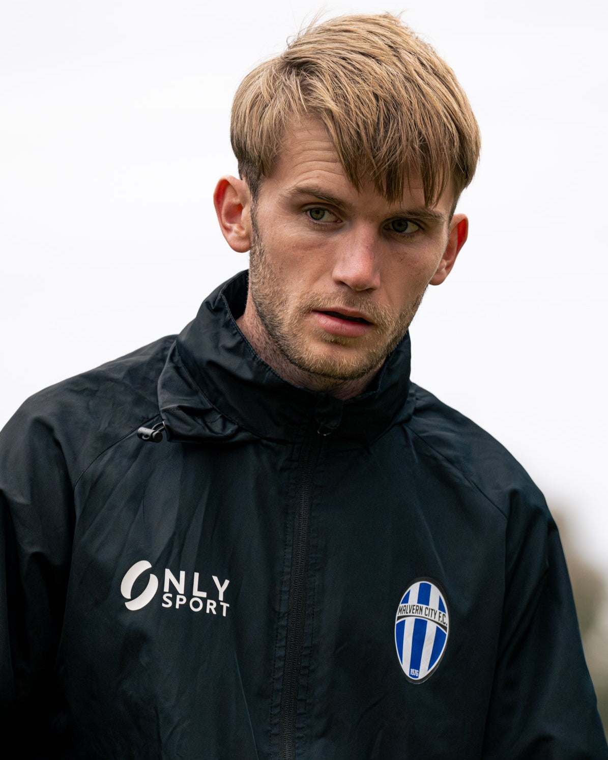 Man wearing a black spray jacket with 'Only Sport' logo