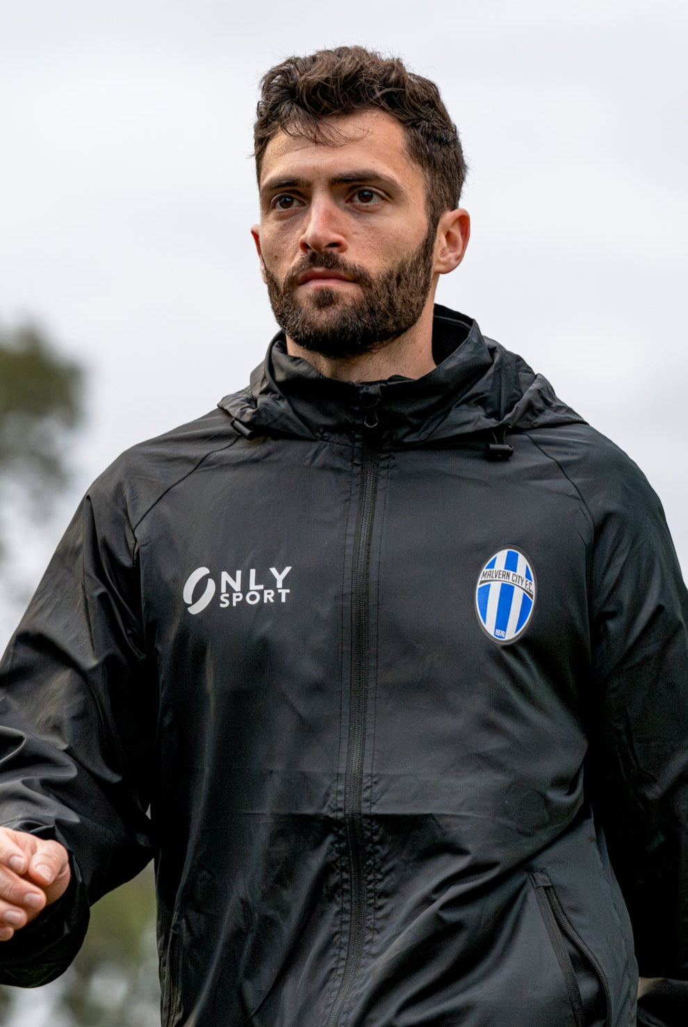 Man wearing a black Spray Jacket outdoors