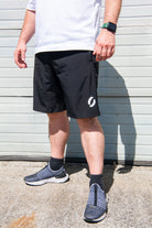 Angled view facing left of person wearing long pocket shorts