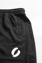 Portrait of zip closed on pocket shorts, demonstrating its concealment 