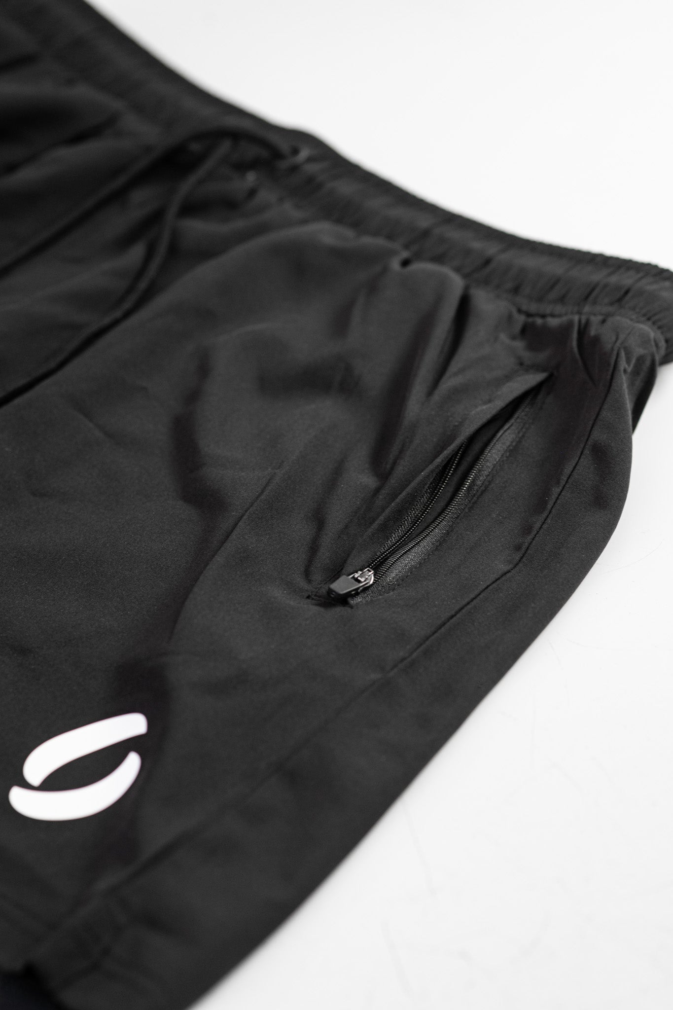 Secondary portrait view of zip opened on pocket shorts