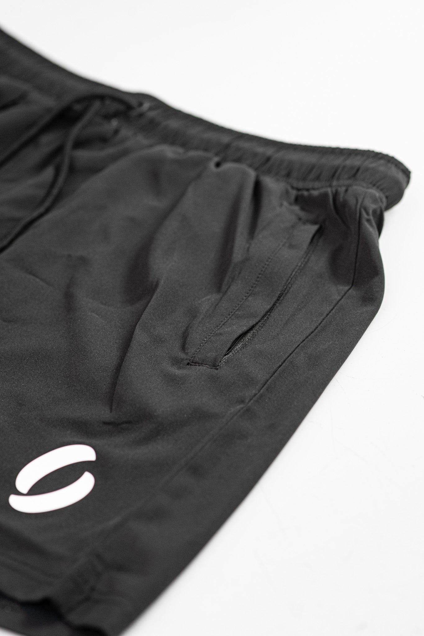 Secondary portrait view of zip closed of pocket shorts as it demonstrates its concealment 