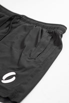 Secondary portrait view of zip closed of pocket shorts as it demonstrates its concealment 