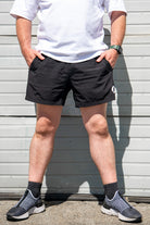 Front view of pocket shorts with hands in pockets