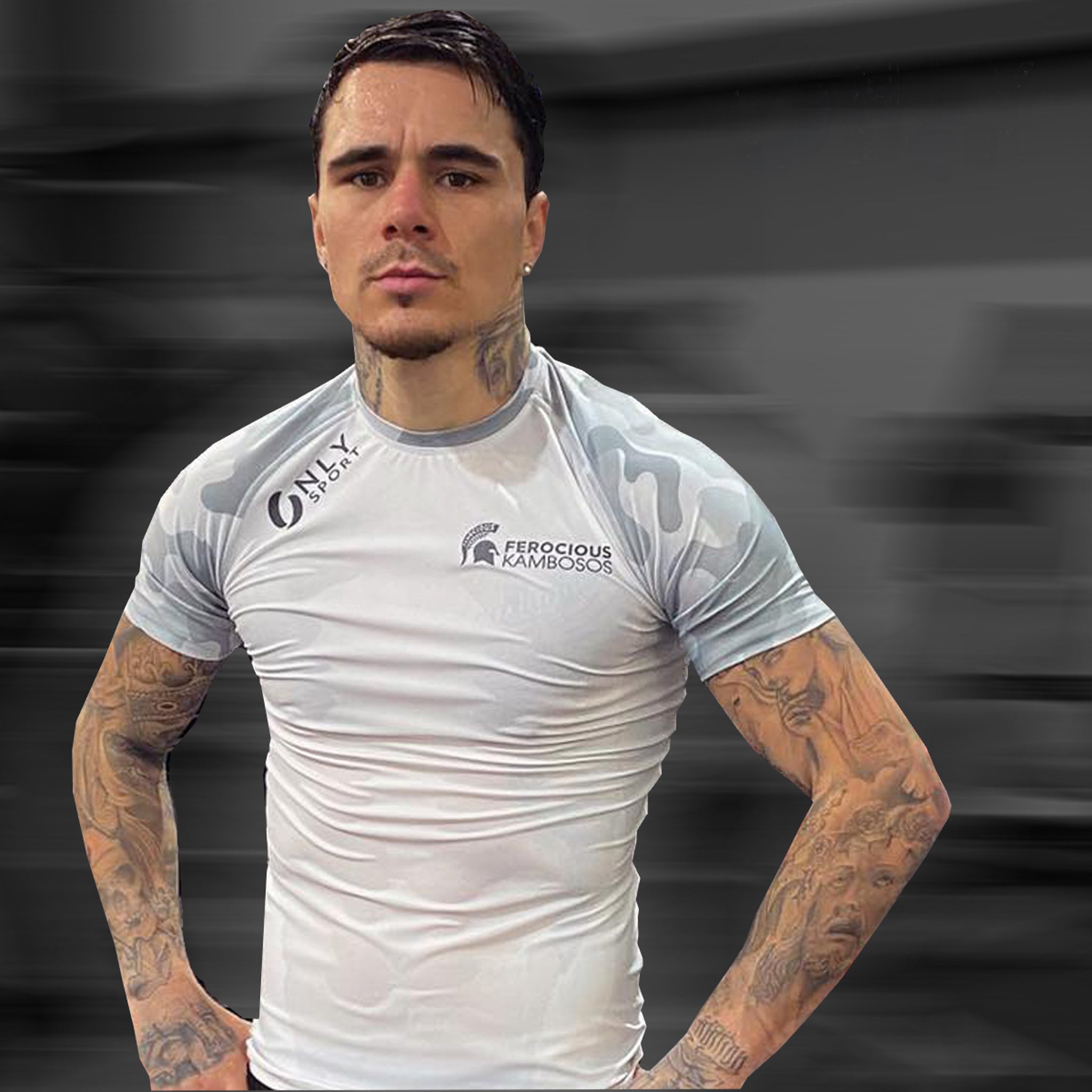Man wearing a white rash guard on a dark background