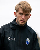 Man wearing a black spray jacket with 'Only Sport' logo 