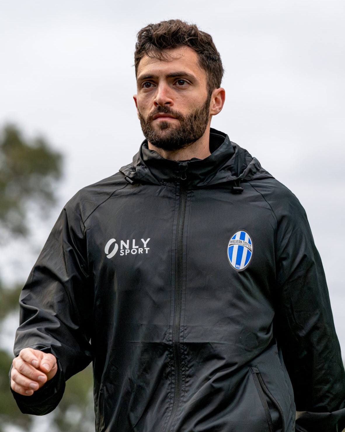 Man wearing a black Spray Jacket outdoors