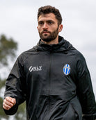 Man wearing a black Spray Jacket outdoors