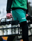 Person carrying a black water bottle carrier with white bottles