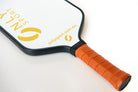 Angled view of white paddle from the top as it lays on the ground 