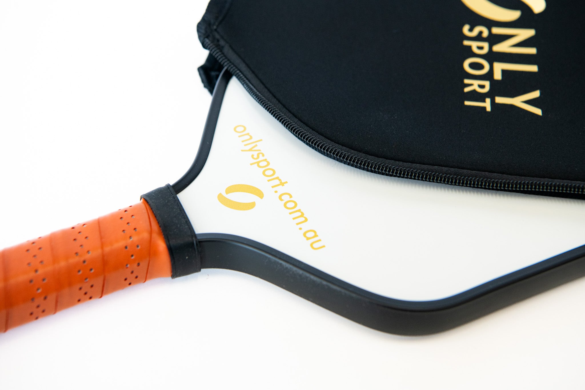 Close angled view of white paddle with cover partially covering it on the ground 