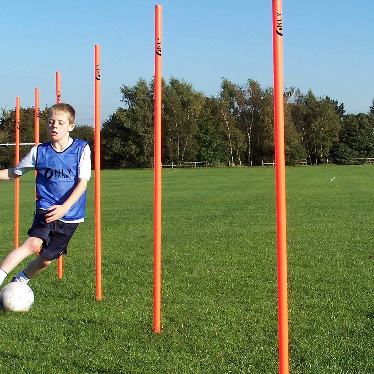 BOY PRACTISING BETWEEN FLEXIBLE AGILITY POLES